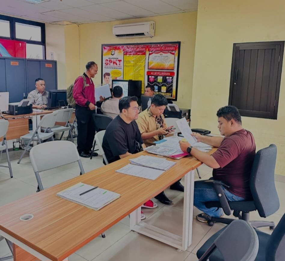 Pelapor dari Yayasan Nusa Jaya tengah menyerahkan berkas laporan dugaan penipuan kepada petugas kepolisian di ruang pelayanan Polres Metro Bekasi Kota, 1 Agustus 2025.