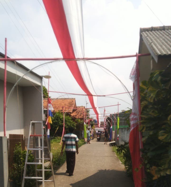 Warga Rawa Mulya Mustika Jaya Kota Bekasi memasang bendera merah putih sepanjang satu kilometer untuk peringatan HUT RI ke-80.